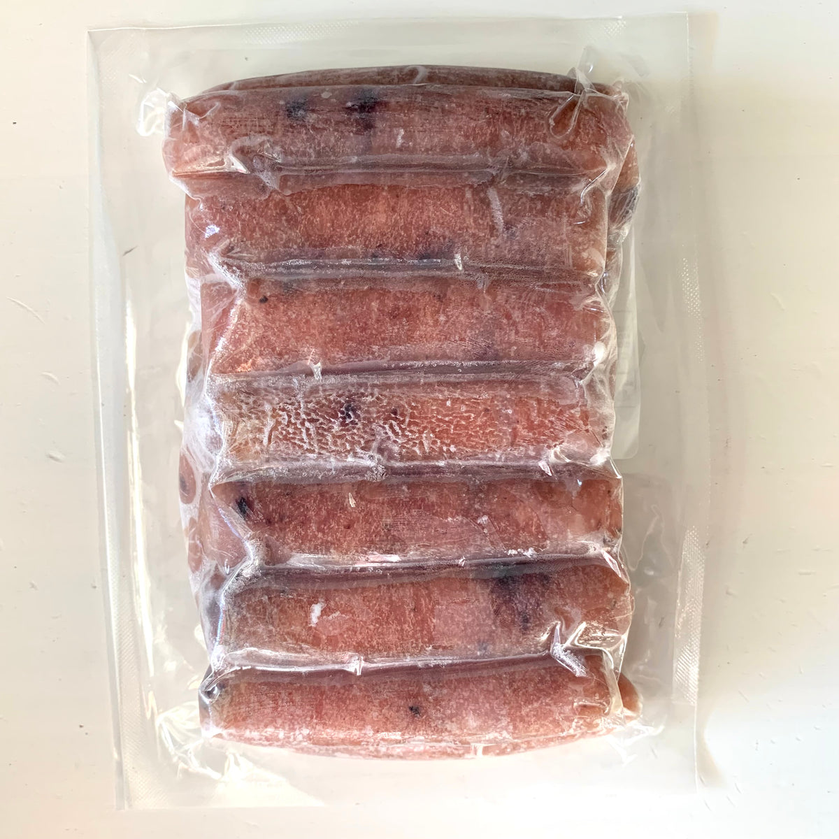 the back of a vacuum sealed package of chicken blueberry maple sausages