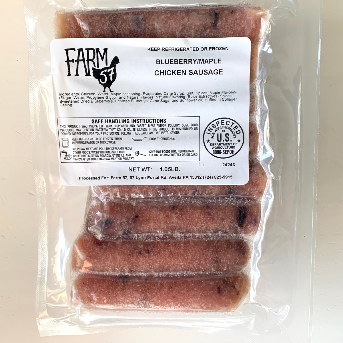 package of raw blueberry maple chicken sausages on a white background