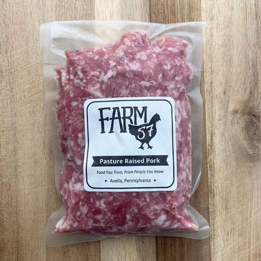 vacuum sealed and frozen pork on a wood cutting board with farm57 label