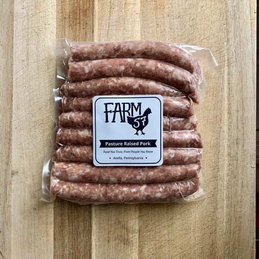 vacuum sealed and frozen maple pork sausage links on wood cutting board with label
