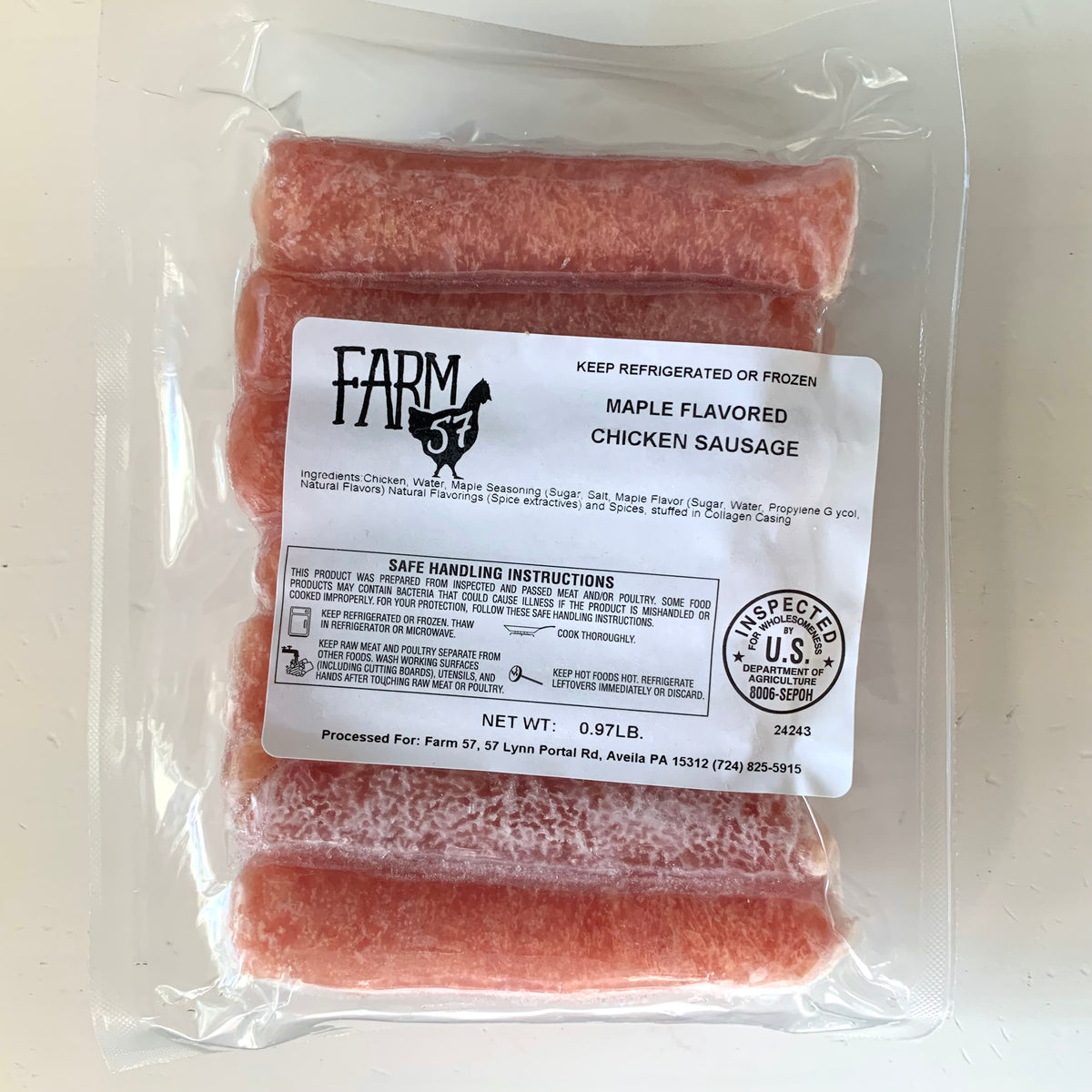 raw packaged maple breakfast sausages on a white background