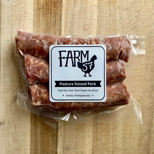 vacuum sealed and frozen sweet italian pork sausage links on wood cutting board with label